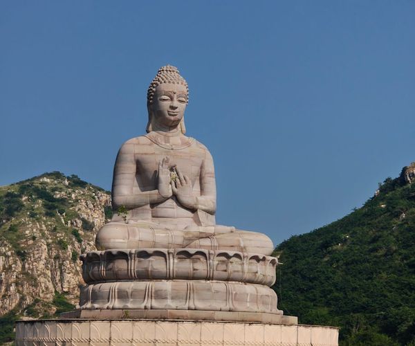 A serene landscape with calm water reflecting the sky, symbolizing inner peace.